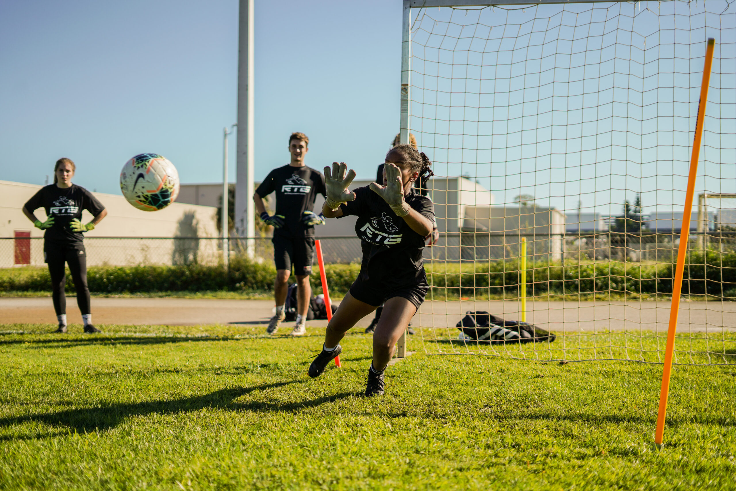 coach demonstrating to players in training